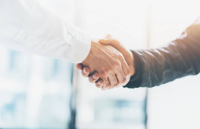 Photo of two men shaking hands