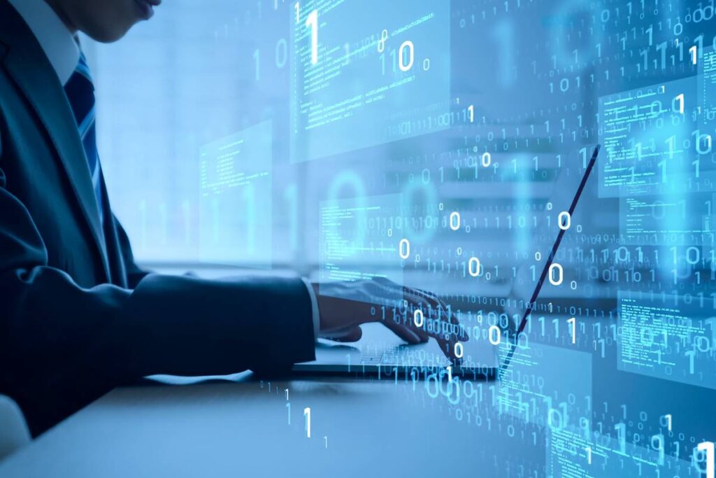 Man in a business suit typing at laptop