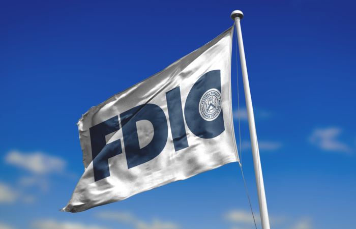 Photo of FDIC flag against a blue sky