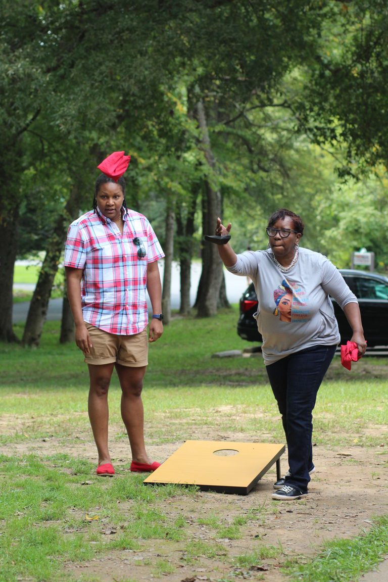 Synergists playing cornhole at company picnic