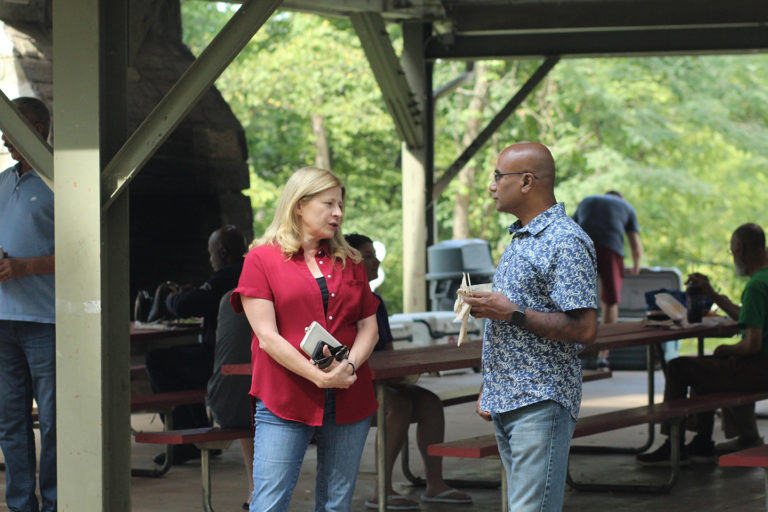 Photo of Synergist talking to Sam Sarkar, Synergys' CEO at the company picnic