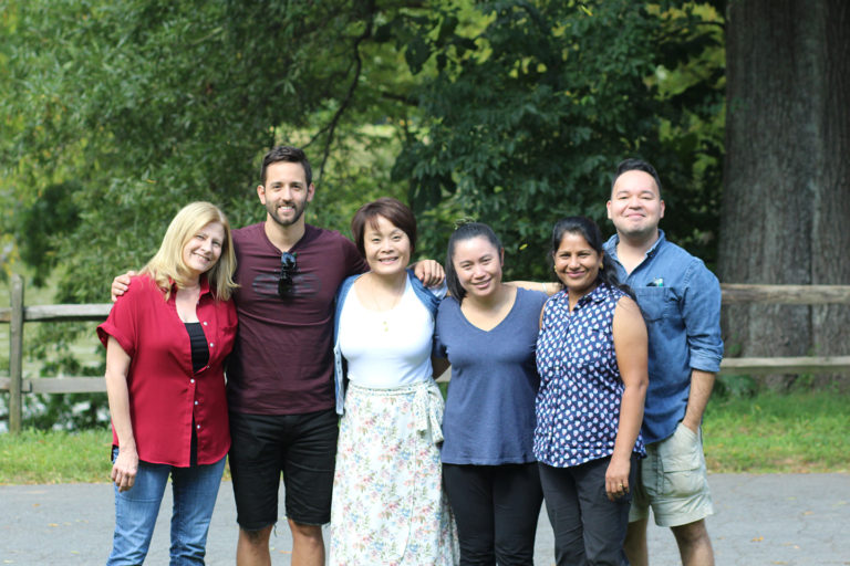 Six team members in a group photo at the company picnic