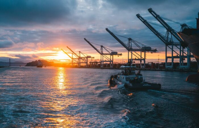 Vessel in a port sailing out towards the sunset