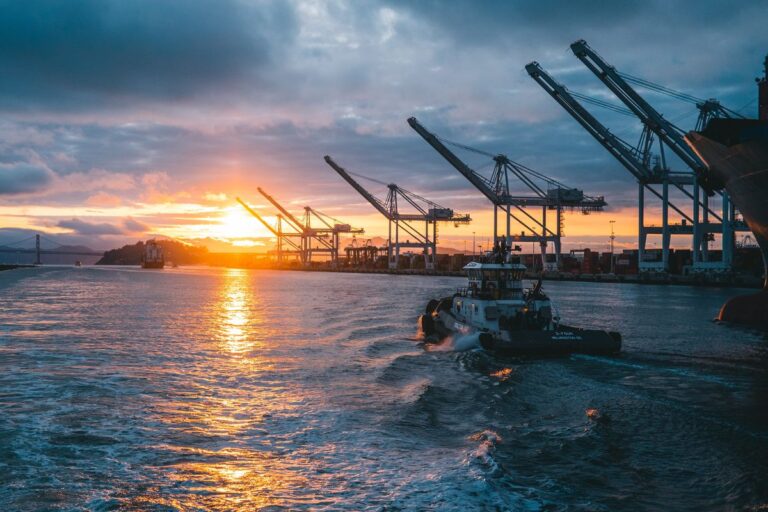 Vessel in a port sailing out towards the sunset