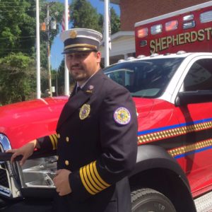 Marshall stands with one of the Shepherdstown Fire Department trucks.