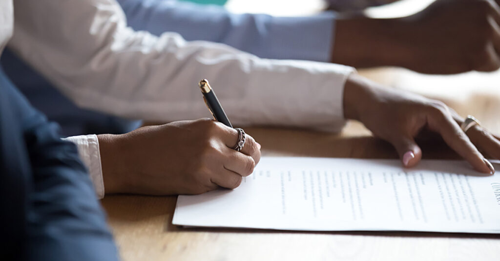 Photo of a woman signing a contract